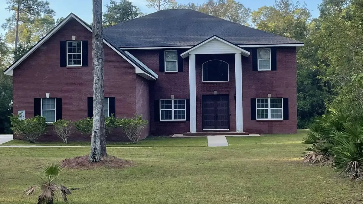 Two-story St. Augustine home with clean brick and siding after exterior washing