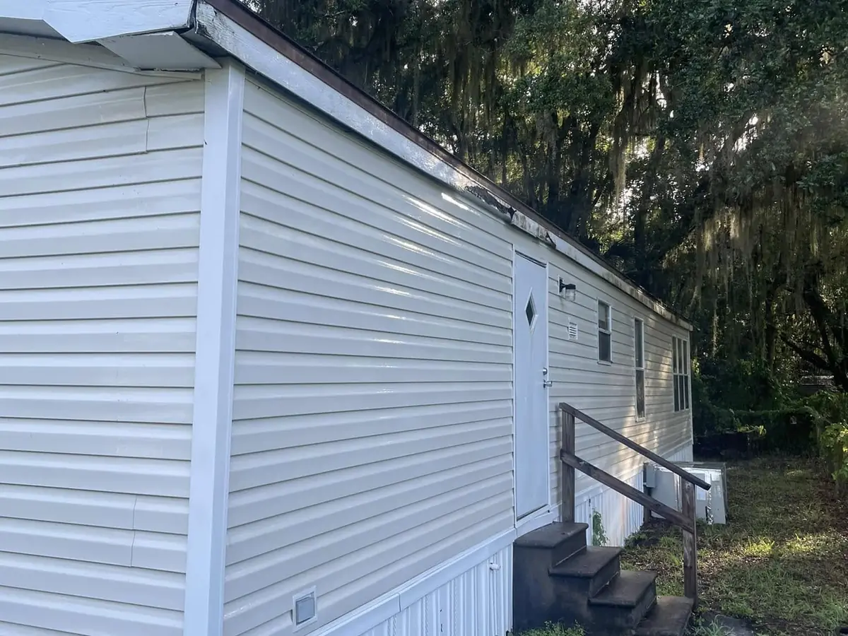 The same home siding cleaned back to its original color